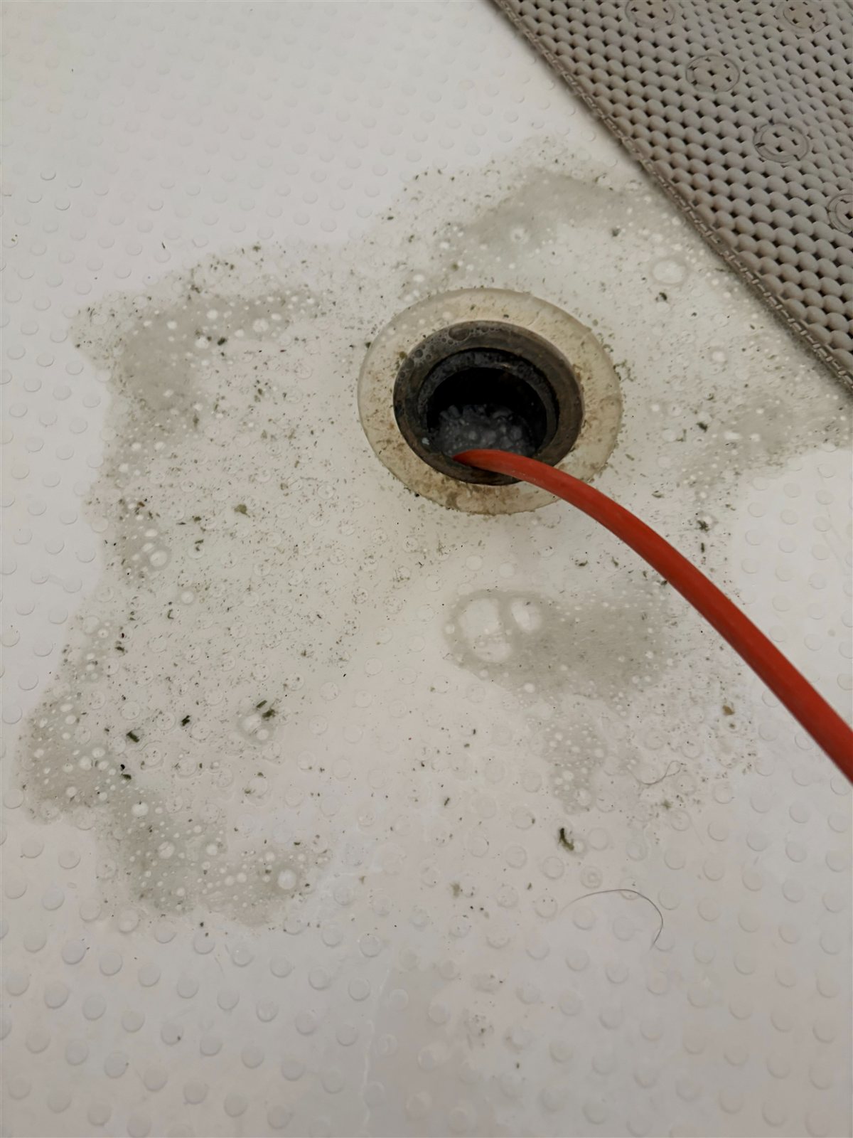 Hydrojetting hose clearing a shower drain in a Las Vegas home